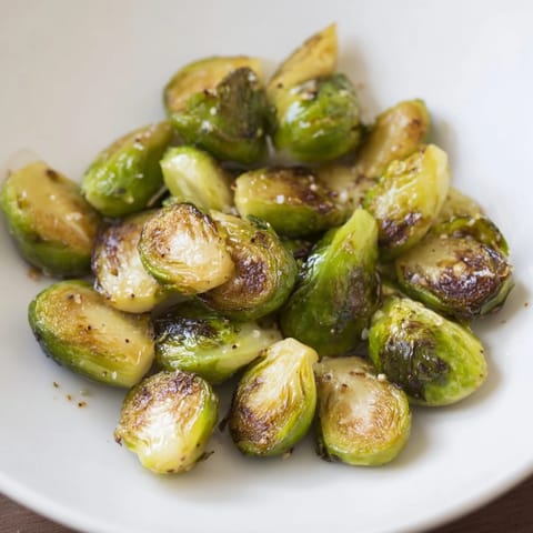 Visualize perfectly caramelized roasted Brussels sprouts, their nutty and sweet flavor enhanced by simple spices.