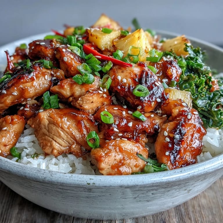 Savory teriyaki chicken and rice bowl served with juicy pineapple, perfect for a quick weeknight dinner.