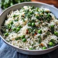 A vibrant Spring Pea and Mint Rice Pilaf with tender peas and fresh mint, served as a fragrant side dish.  