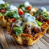 Mini taco cups in wonton wrappers, baked golden with melted cheese.